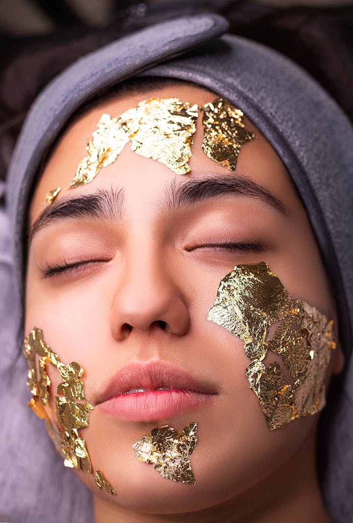 Close-up of a woman with gold leaf facial mask in spa, Tehran.